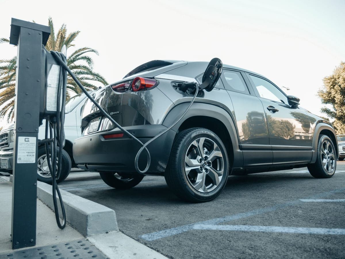An electric car charging overnight in a home driveway